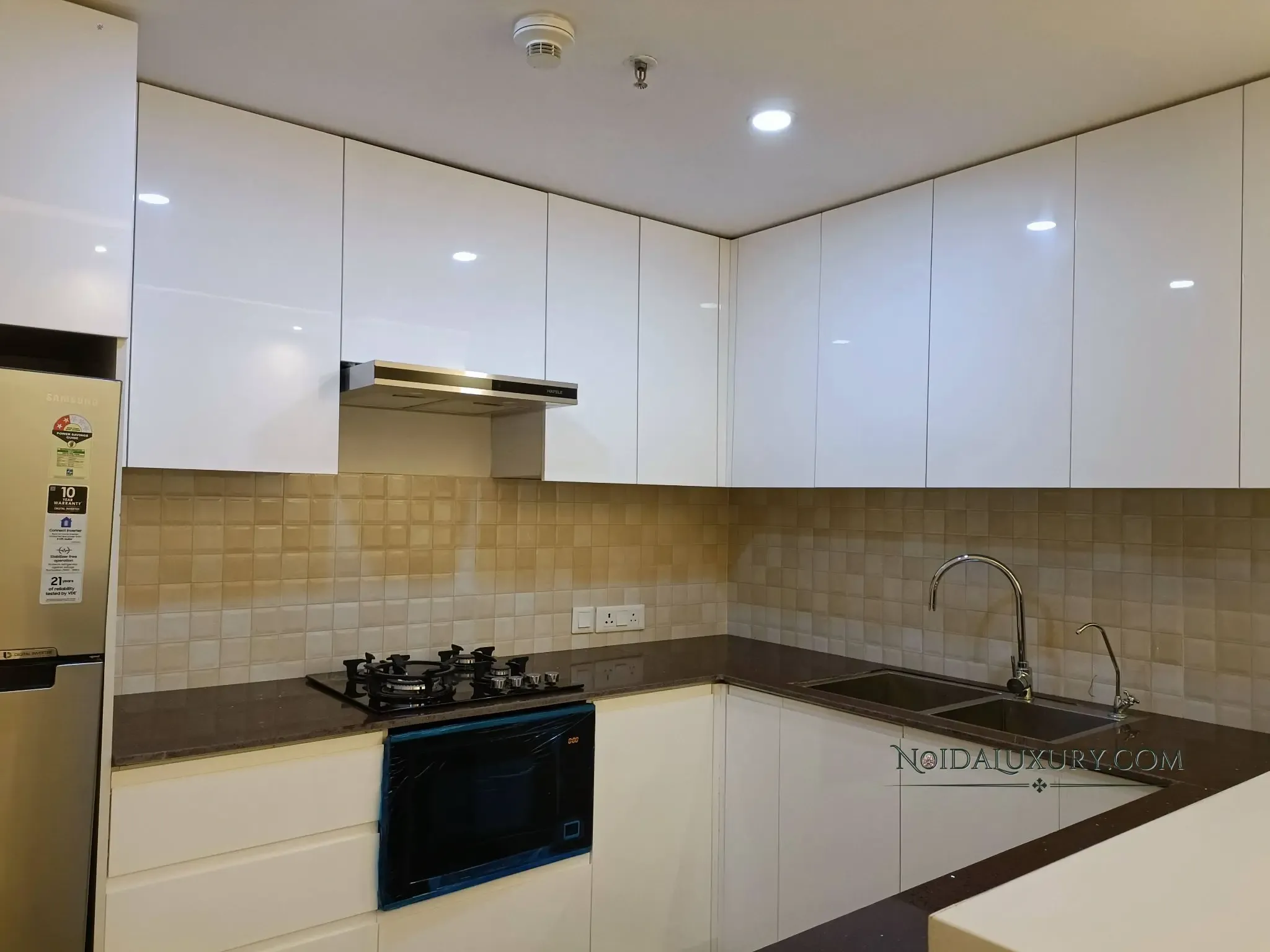 3 BHK apartment interior at Supernova – modern modular kitchen with chimney and appliances